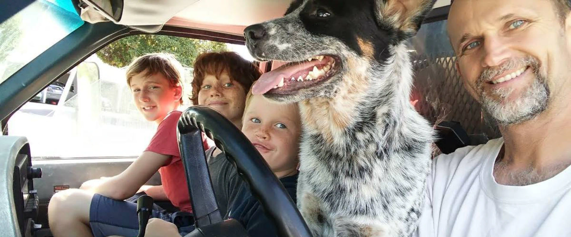 family photo inside of car and with pet dog